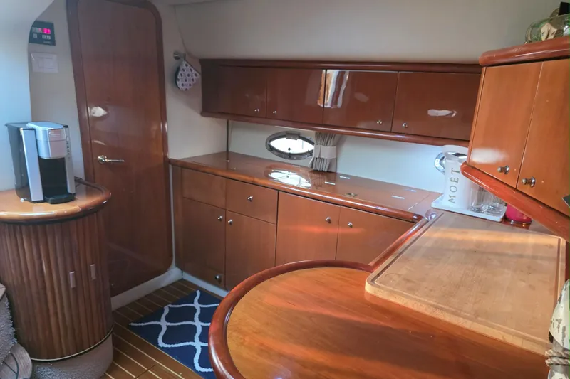 Kings Corner Yacht Photos Pics Luxurious 2001 Sunseeker Camargue 44 yacht interior with wooden cabinetry and modern amenities.