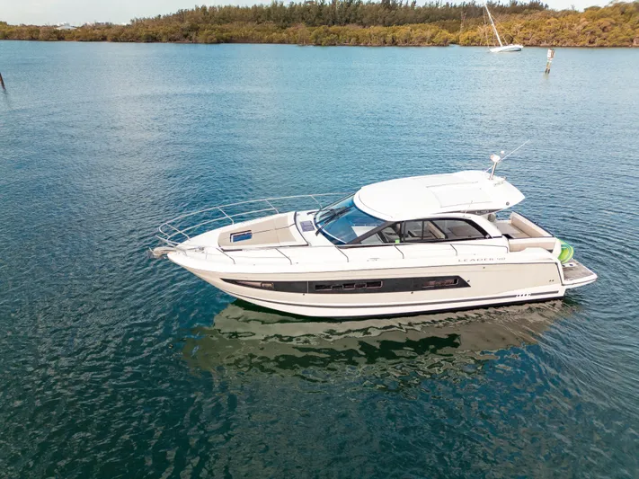 Chichochu Yacht Photos Pics 2017 Jeanneau Leader 40 yacht on calm water, surrounded by lush greenery.