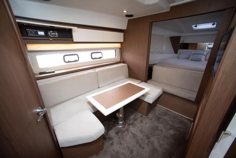 Chichochu Yacht Photos Pics 2017 Jeanneau Leader 40 interior with cozy seating and elegant wood finishes.