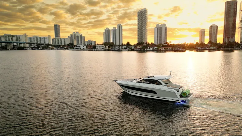 Chichochu Yacht Photos Pics Jeanneau Leader 40 yacht cruising at sunset near city skyline, 2017 model.