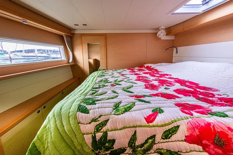  Yacht Photos Pics Luxurious 2017 Lagoon 52 S yacht cabin with floral bedding and scenic window view.
