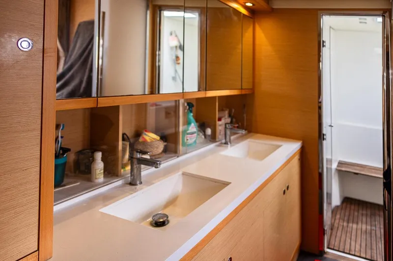  Yacht Photos Pics Luxurious bathroom interior of 2017 Lagoon 52 S yacht with dual sinks and wooden accents.