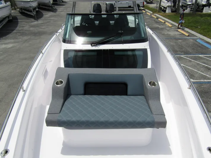  Yacht Photos Pics 2024 Axopar 37 Sun Top boat with cushioned seating and sleek windshield design.