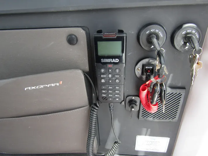  Yacht Photos Pics Control panel of 2024 Axopar 37 Sun Top with Simrad radio and ignition keys.