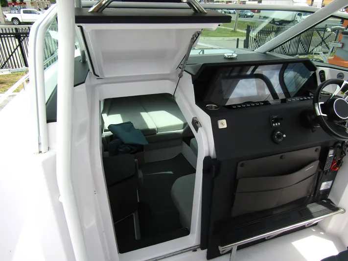  Yacht Photos Pics 2024 Axopar 37 Sun Top interior with helm and cabin view.