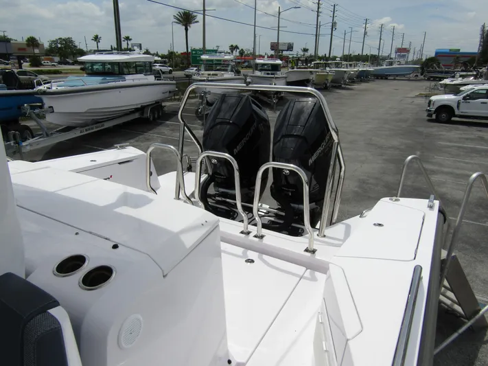  Yacht Photos Pics 2024 Axopar 37 Sun Top with dual outboard engines in a marina setting.