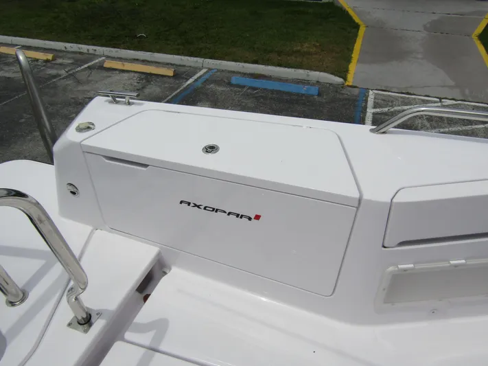  Yacht Photos Pics 2024 Axopar 37 Sun Top boat detail, featuring sleek white design and branding.