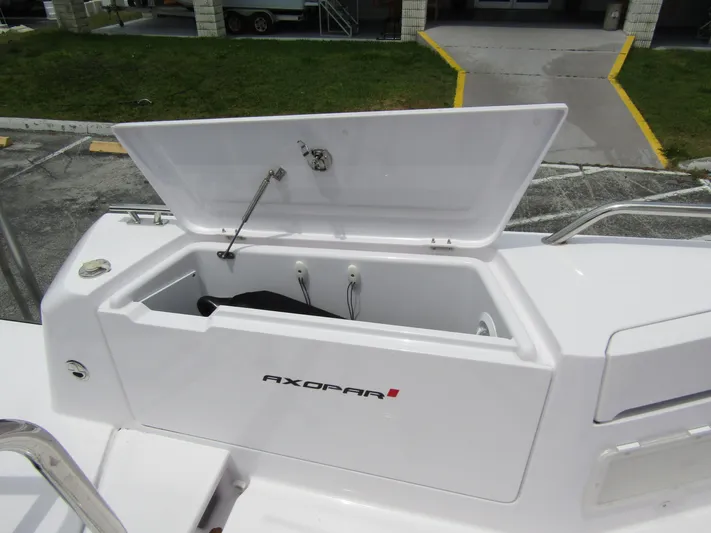  Yacht Photos Pics 2024 Axopar 37 Sun Top storage compartment open, showcasing spacious interior design.