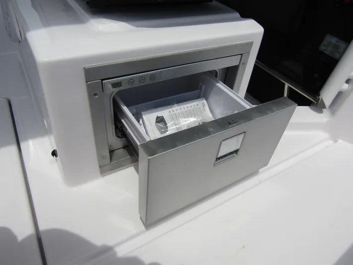  Yacht Photos Pics 2024 Axopar 37 Sun Top boat with an open stainless steel drawer refrigerator.