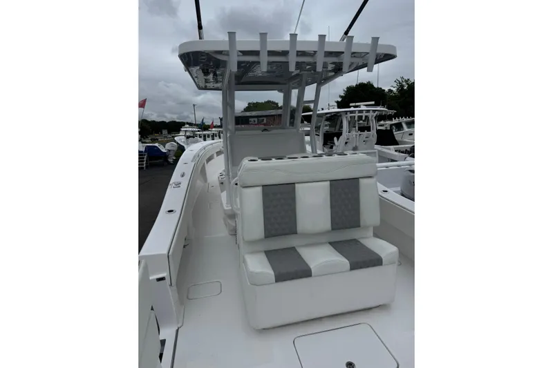  Yacht Photos Pics 2024 Invincible 36 Open Fisherman boat with cushioned seating and T-top, docked outdoors.