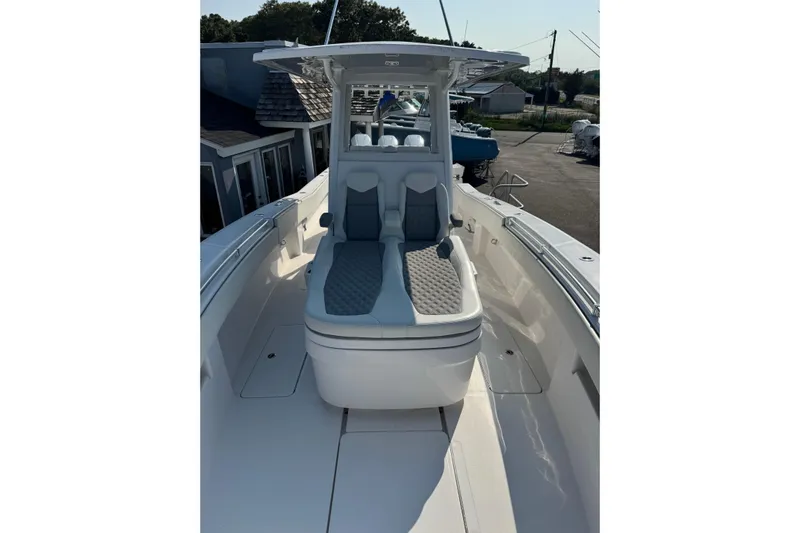  Yacht Photos Pics 2024 Invincible 36 Open Fisherman boat with cushioned seating and sleek design.