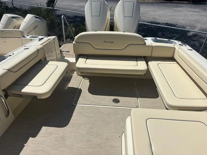  Yacht Photos Pics 2025 Chris-Craft Calypso 32 boat interior with beige seating and twin outboard engines.
