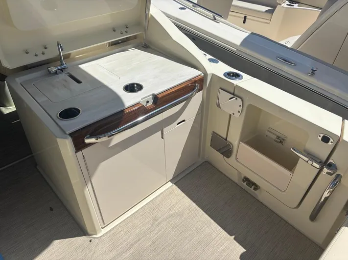  Yacht Photos Pics 2025 Chris-Craft Calypso 32 boat interior with kitchenette and storage compartments.