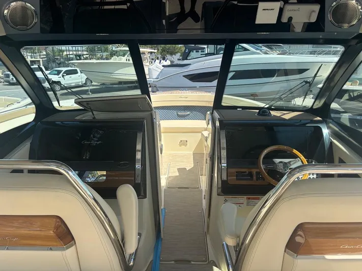  Yacht Photos Pics 2025 Chris-Craft Calypso 32 cockpit with dual helm seats and modern dashboard.