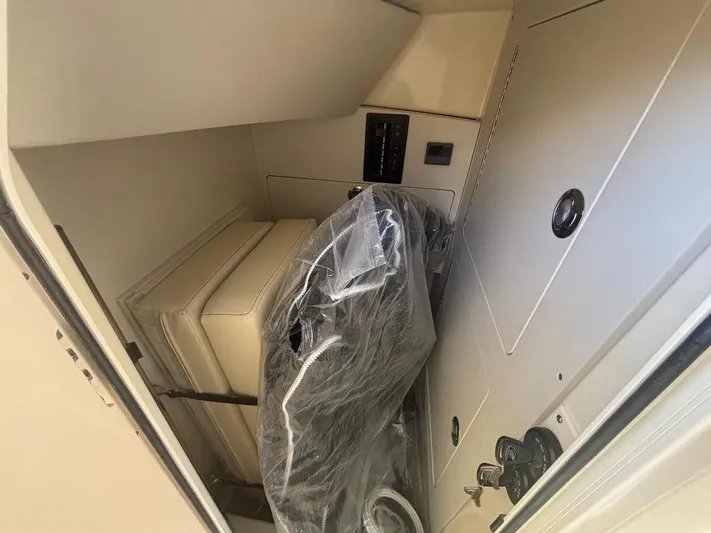  Yacht Photos Pics 2025 Chris-Craft Calypso 32 interior storage area with wrapped seating.