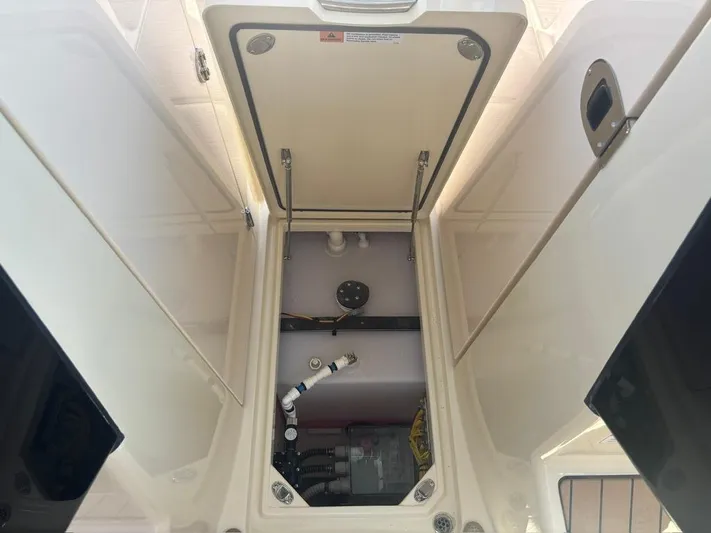  Yacht Photos Pics 2025 Chris-Craft Calypso 32 storage compartment with open hatch and visible equipment.