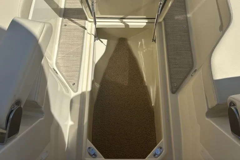  Yacht Photos Pics 2025 Chris-Craft Calypso 32 boat interior storage compartment with carpeted flooring.