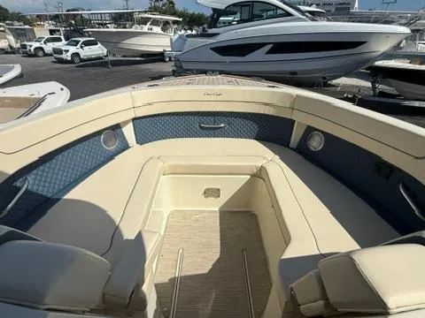  Yacht Photos Pics 2025 Chris-Craft Calypso 32 boat interior with beige seating and blue accents.
