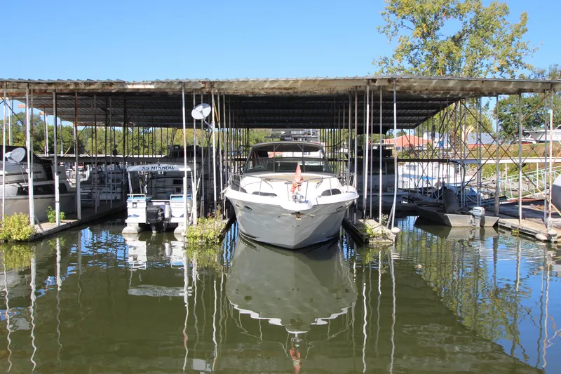  Yacht Photos Pics 2001 Sea Ray 460 Sundancer docked in a marina under a covered slip.
