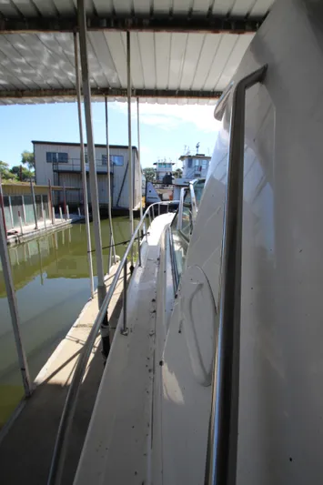  Yacht Photos Pics 2001 Sea Ray 460 Sundancer docked in marina, side view.