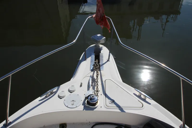  Yacht Photos Pics Bow view of 2001 Sea Ray 460 Sundancer yacht with anchor chain and calm water.