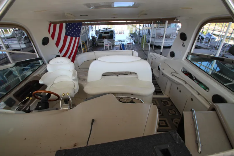  Yacht Photos Pics Interior of 2001 Sea Ray 460 Sundancer yacht with American flag and seating area.
