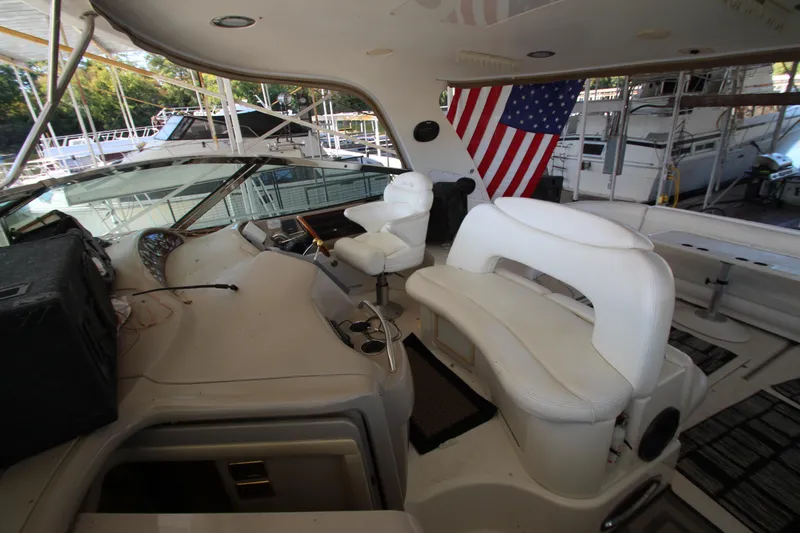  Yacht Photos Pics Interior of 2001 Sea Ray 460 Sundancer yacht with white seating and American flag.