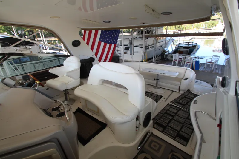  Yacht Photos Pics 2001 Sea Ray 460 Sundancer yacht interior with seating and American flag.