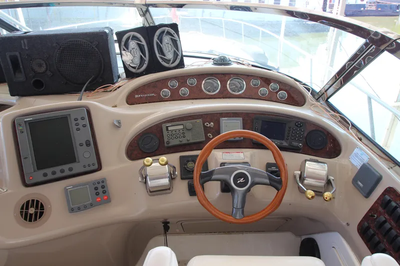  Yacht Photos Pics 2001 Sea Ray 460 Sundancer helm with navigation instruments and wood-accented steering wheel.
