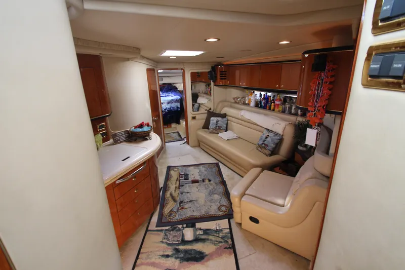  Yacht Photos Pics Luxurious interior of 2001 Sea Ray 460 Sundancer yacht with cozy seating and elegant decor.