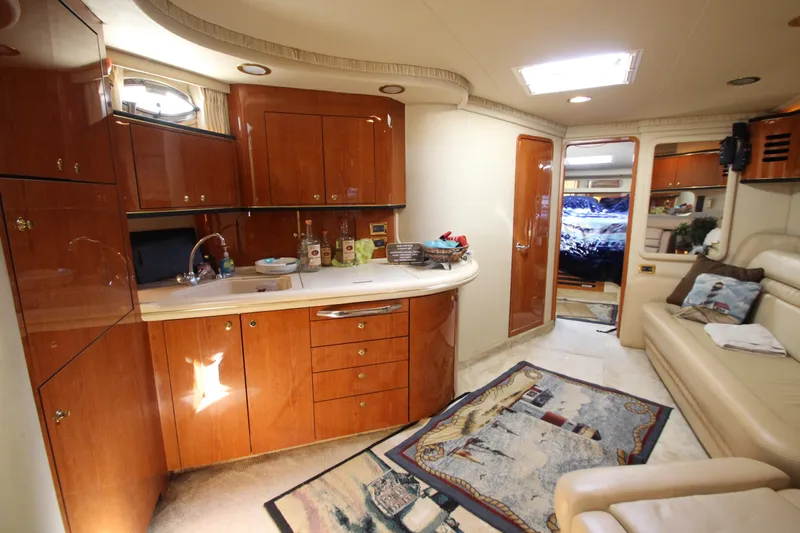  Yacht Photos Pics Luxurious 2001 Sea Ray 460 Sundancer yacht interior with elegant wood cabinetry and cozy seating.
