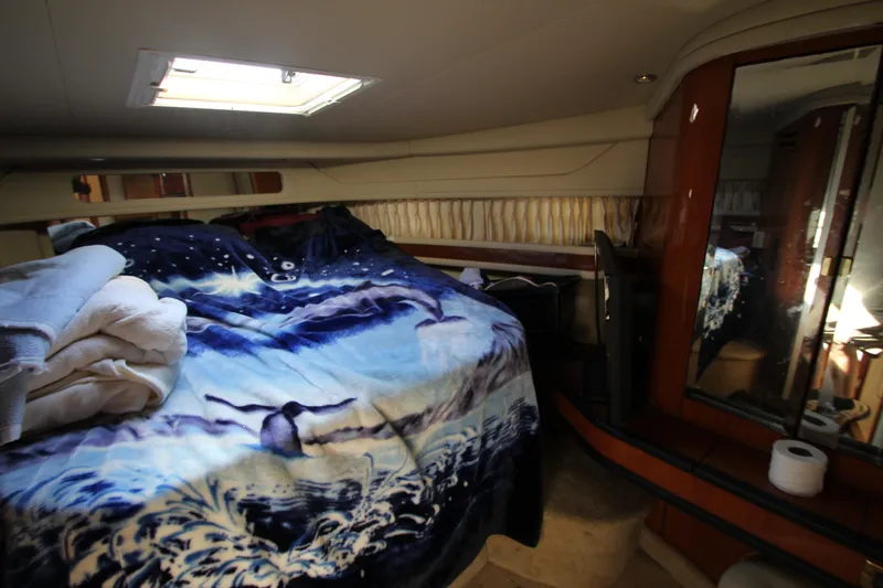  Yacht Photos Pics Cozy bedroom in 2001 Sea Ray 460 Sundancer yacht with ocean-themed bedding.