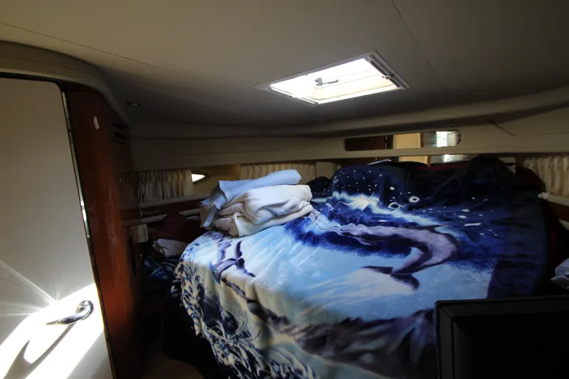  Yacht Photos Pics Cozy cabin interior of 2001 Sea Ray 460 Sundancer with skylight and patterned bedding.