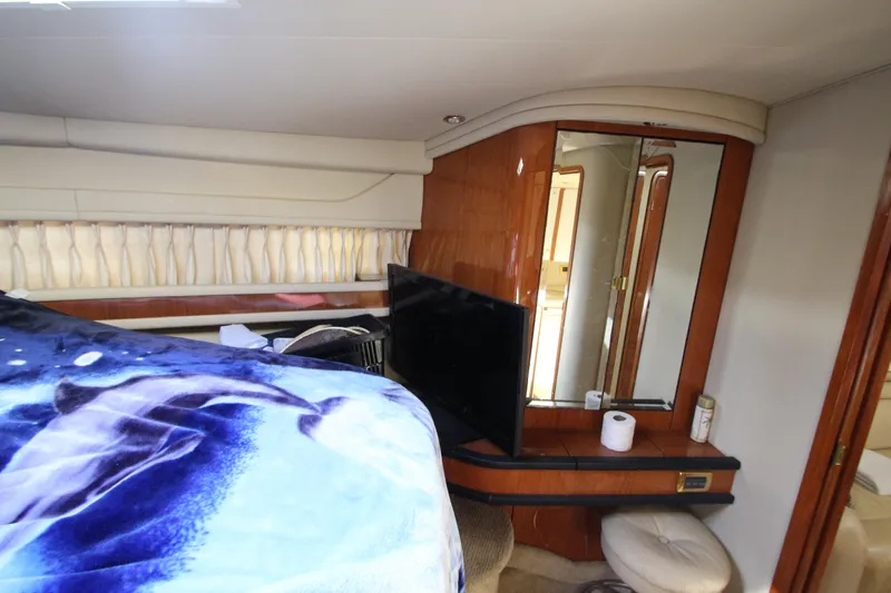  Yacht Photos Pics Interior of 2001 Sea Ray 460 Sundancer yacht with bed, TV, and mirror.