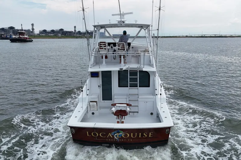 Loca Louise Yacht Photos Pics 2002 Hatteras 50 Convertible Sportfish boat cruising on open water.
