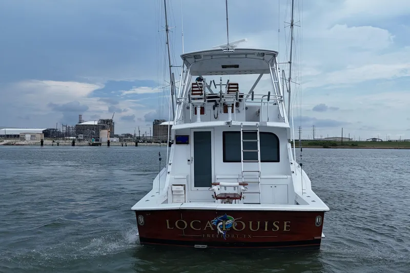 Loca Louise Yacht Photos Pics 2002 Hatteras 50 Convertible Sportfish boat on water, rear view, overcast sky.