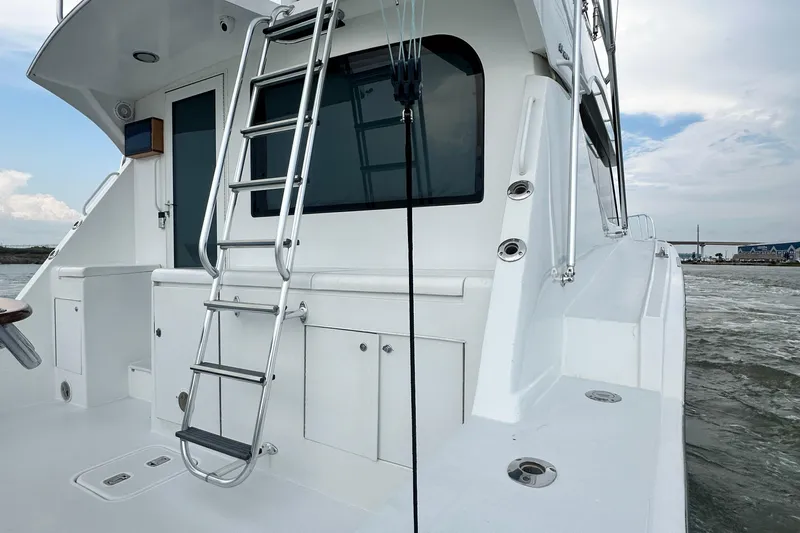 Loca Louise Yacht Photos Pics 2002 Hatteras 50 Convertible Sportfish yacht with ladder and ocean view.