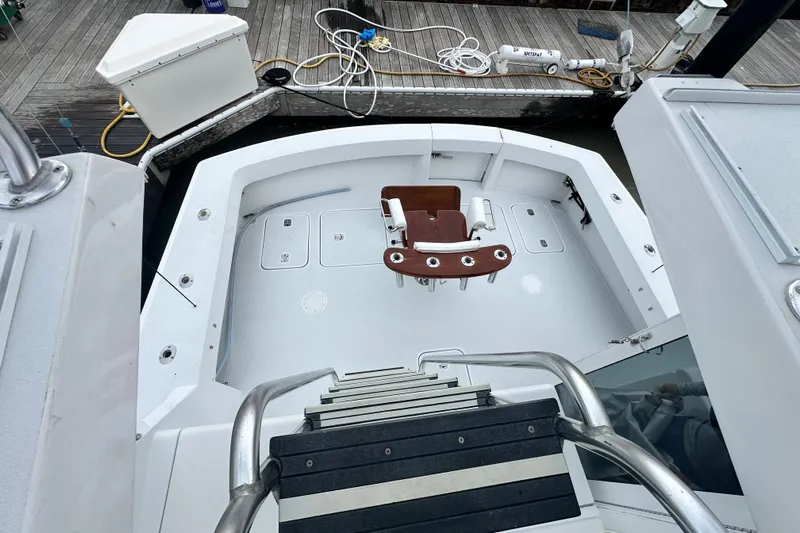Loca Louise Yacht Photos Pics 2002 Hatteras 50 Convertible Sportfish cockpit with fishing chair and dock view.