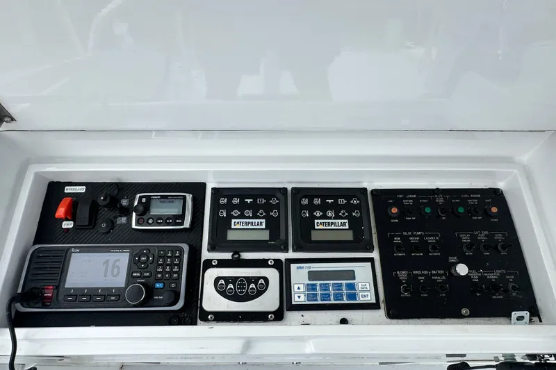 Loca Louise Yacht Photos Pics Control panel of a 2002 Hatteras 50 Convertible Sportfish boat, featuring navigation and engine controls.