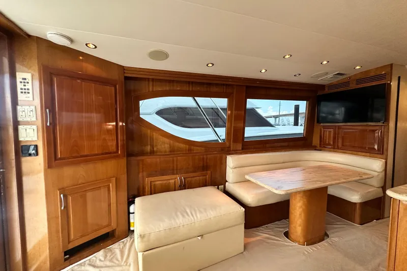Loca Louise Yacht Photos Pics Luxurious interior of 2002 Hatteras 50 Convertible Sportfish with wood paneling and dining area.