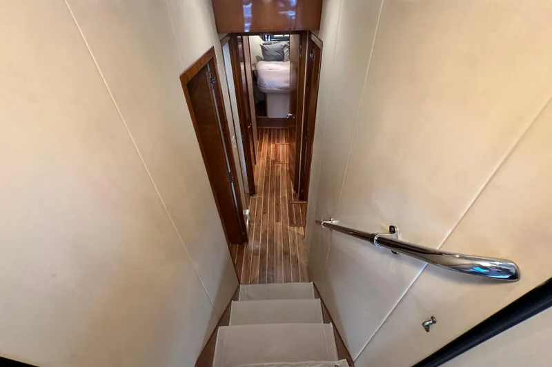 Loca Louise Yacht Photos Pics Interior hallway of 2002 Hatteras 50 Convertible Sportfish yacht with wooden flooring.