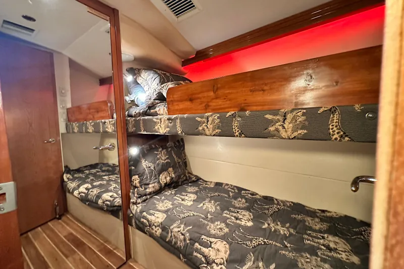 Loca Louise Yacht Photos Pics 2002 Hatteras 50 Convertible Sportfish cabin with bunk beds and animal-themed bedding.