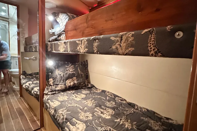 Loca Louise Yacht Photos Pics Bunk beds with safari-themed bedding in 2002 Hatteras 50 Convertible Sportfish yacht cabin.