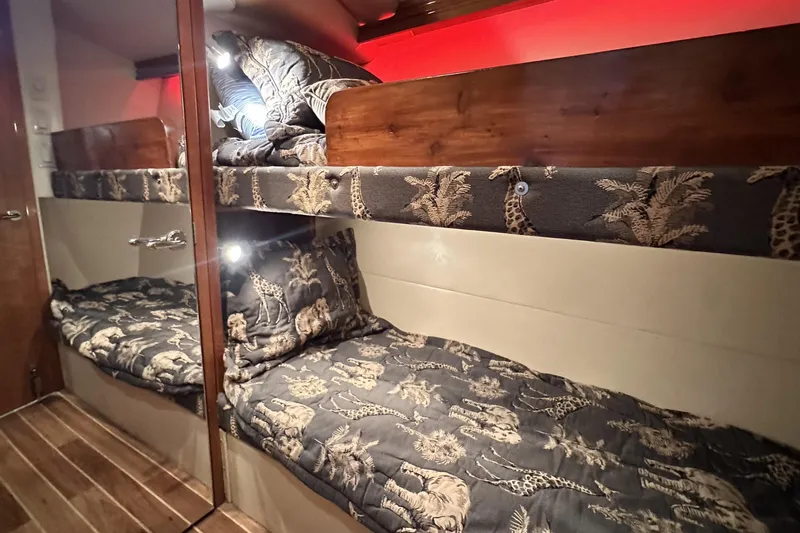 Loca Louise Yacht Photos Pics Bunk beds with animal print bedding in 2002 Hatteras 50 Convertible Sportfish yacht cabin.