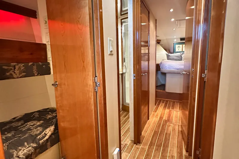 Loca Louise Yacht Photos Pics Interior of 2002 Hatteras 50 Convertible Sportfish with wood flooring and cozy sleeping quarters.