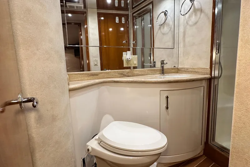 Loca Louise Yacht Photos Pics Luxurious bathroom in 2002 Hatteras 50 Convertible Sportfish yacht, featuring modern fixtures and elegant design.