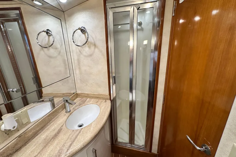 Loca Louise Yacht Photos Pics Bathroom interior of 2002 Hatteras 50 Convertible Sportfish yacht with sink and shower.