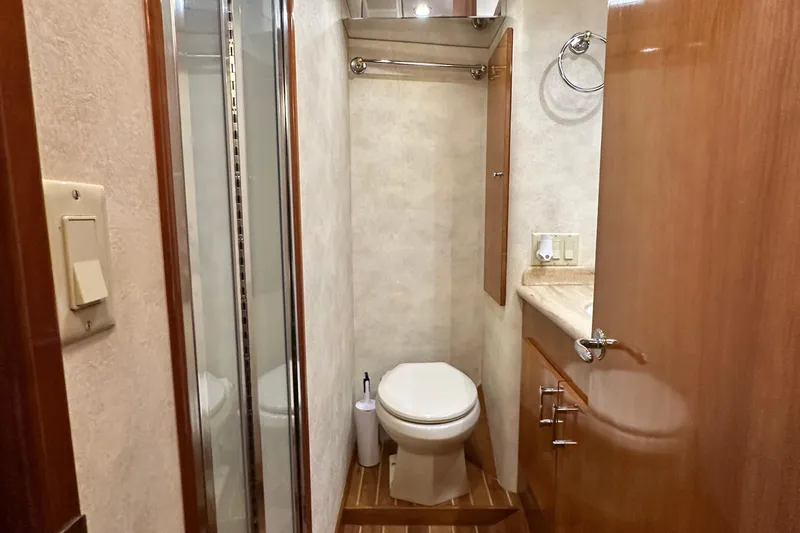 Loca Louise Yacht Photos Pics Bathroom interior of 2002 Hatteras 50 Convertible Sportfish yacht, featuring toilet and shower.