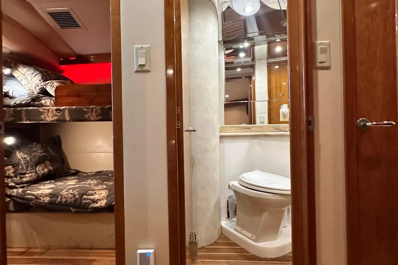 Loca Louise Yacht Photos Pics Interior of 2002 Hatteras 50 Convertible Sportfish with bunk beds and bathroom.