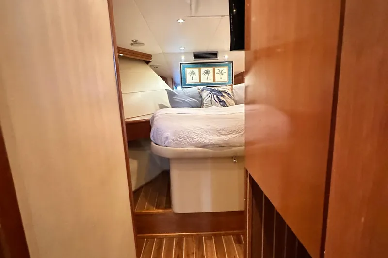 Loca Louise Yacht Photos Pics Interior cabin of 2002 Hatteras 50 Convertible Sportfish with cozy bed and wooden decor.